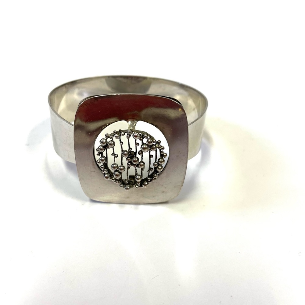 Contemporary silver tone metal abstract bangle bracelet